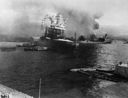 Neosho (AO-23) backs away from the Ford Island loading dock during the air raid on Pearl Harbor. (National Archives)