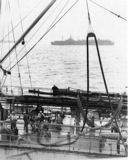The cluttered well deck of a Kennebec-class oiler as her deck crew stands by during fueling operations conducted in smooth seas. Note the fuel line has been assembled from various lengths of 6-inch-diameter rubber hose. Compare the saddle details--which remained essentially unchanged from the 1920s--with those in the photograph on page 33. (National Archives) 