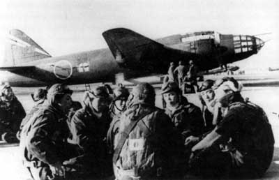 Japanese 
bomber crews on standby for a kamikaze mission relax on an airfield in Japan in 
spring 1945.