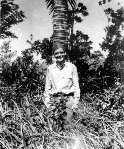 Lieutenant Bob Wallace poses in the jungle on Guam.