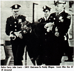 Police carry John Lewis - SNCC Chairman - to paddy wagon.